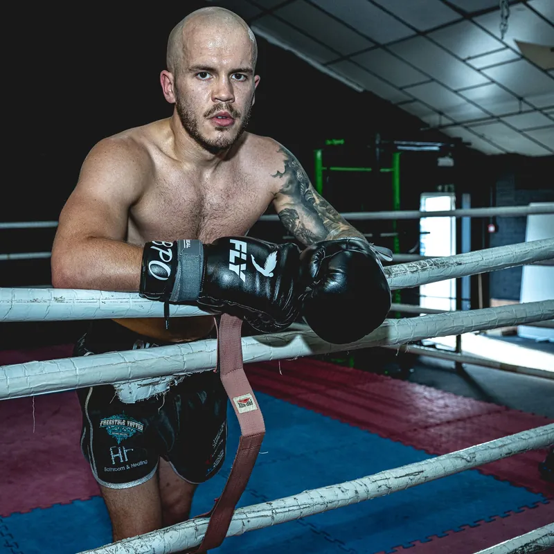 Bradley O'Connor leaning on the ring ropes in his gloves
