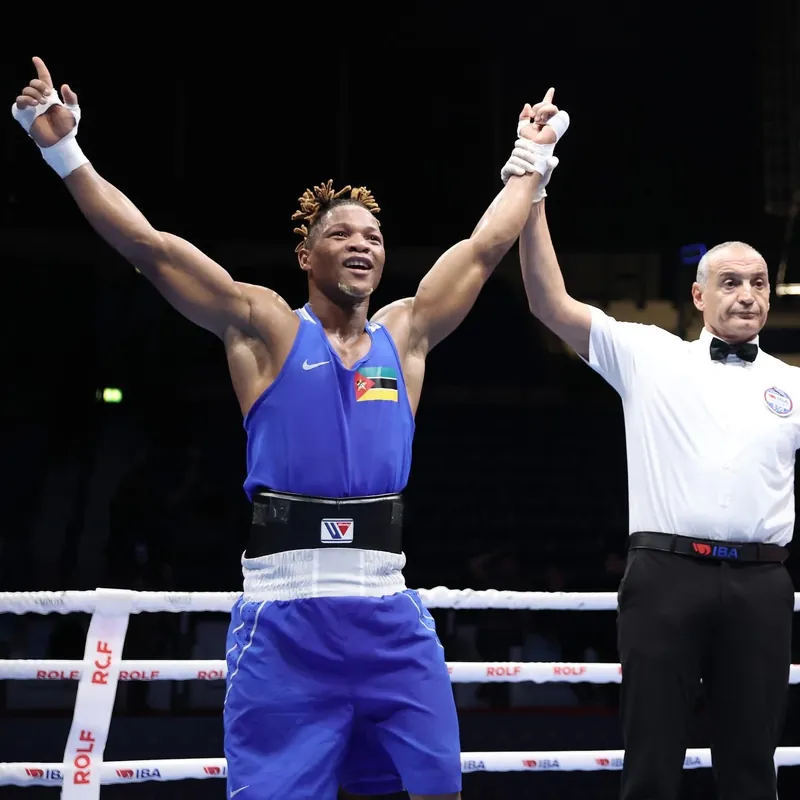 Tiago Muxanga in a blue vest with his arms raised in the ring at the IBA World Championships in Dubai
