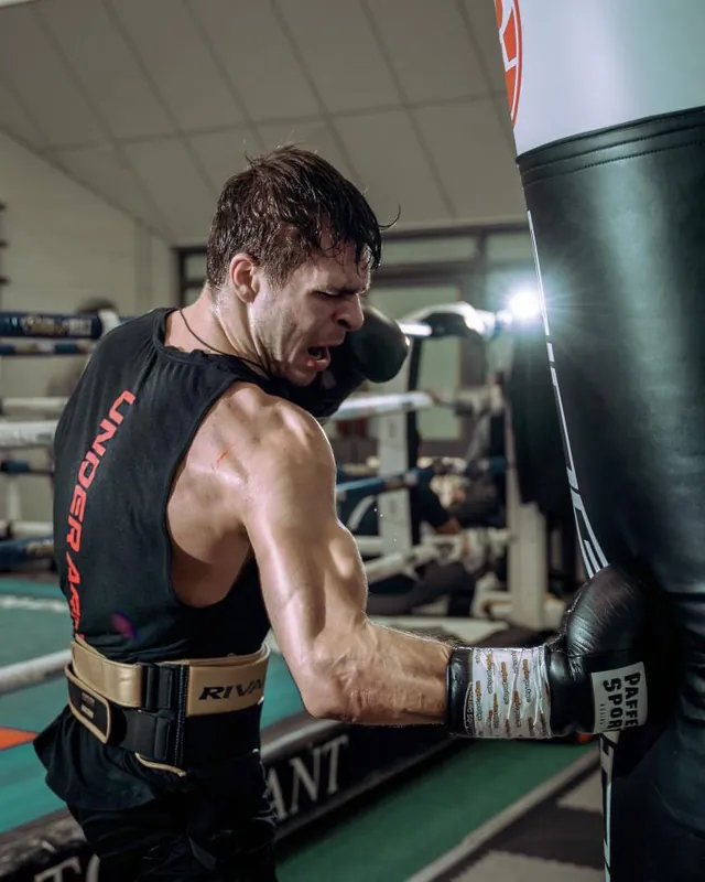 Constantin Ursu hitting a heavy bag hard during a training camp