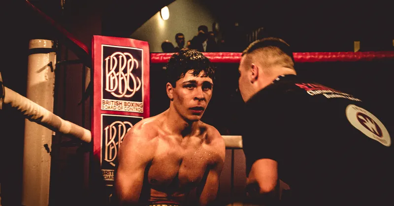 Constantin Ursu sitting in the corner on his pro debut night