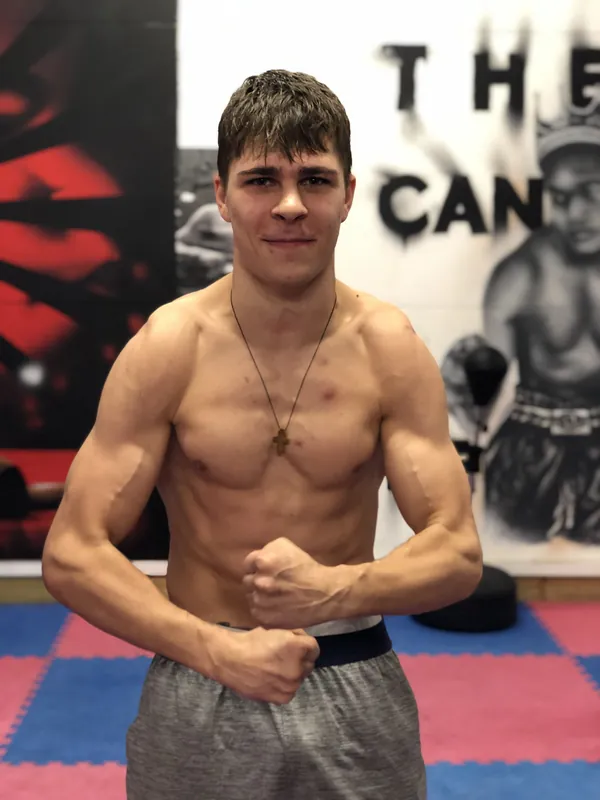 A young Constantin Ursu, shirtless, flexing at Intense Boxing in February 2019