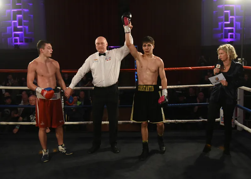 The referee raises Constantin Ursu's hand after his professional debut