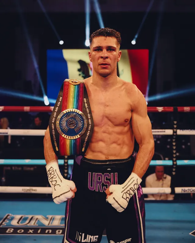 Constantin Ursu as champion, with the Commonwealth belt over his shoulder and the flag of Moldova behind him